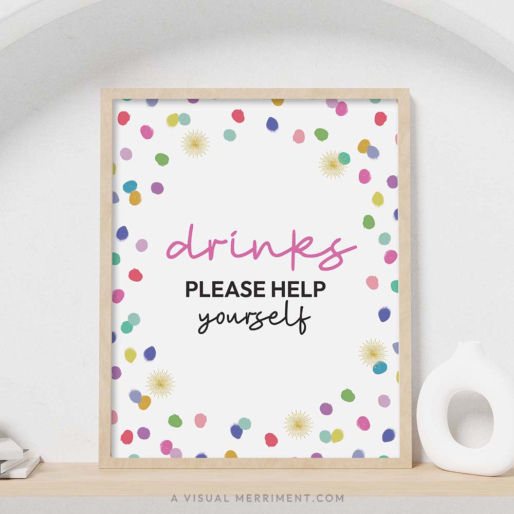 colorful rainbow confetti polka dots ‘Drinks please help yourself’ party sign in a frame sitting on a shelf