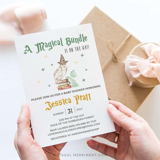 hands holding baby shower wizard school invitation in a harry potter theme with magical elements