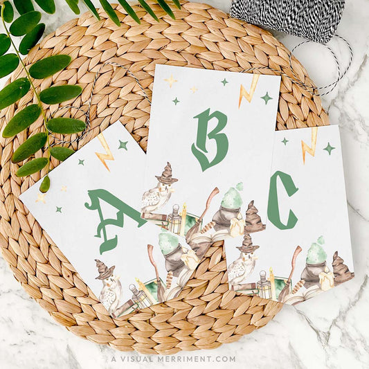 3 letter banner flags in harry potter style with magic wizard school elements on mat with twine and leaves