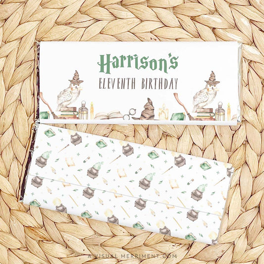 2 printable chocolate wrappers on mat with wizard school design for harry potter style birthday