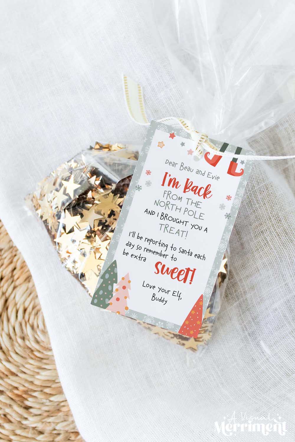 vertical elf on the shelf i’m back gift tag tied to bag of glitter sparkles