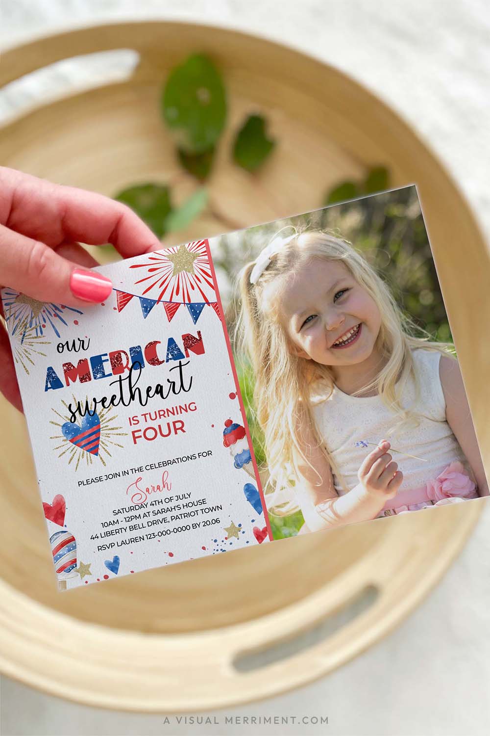 vertical of hand holding american sweetheart 4th of july invitation with image of girl