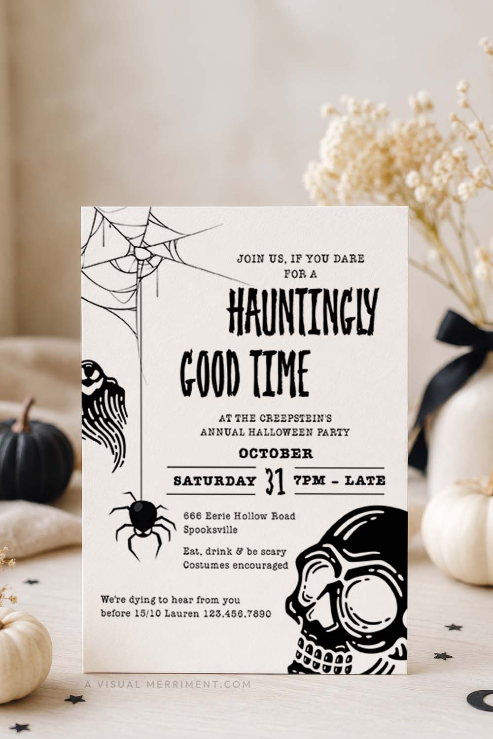 vertical of black and white halloween invitation with spider web, ghost and skull design on card styled on a tabletop with coordinating props
