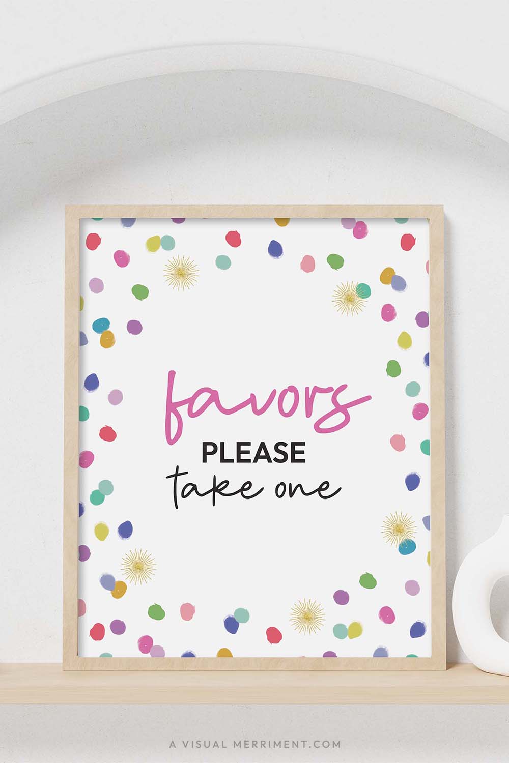 colorful rainbow confetti polka dots ‘Favors please take one’ party sign in a frame sitting on a shelf