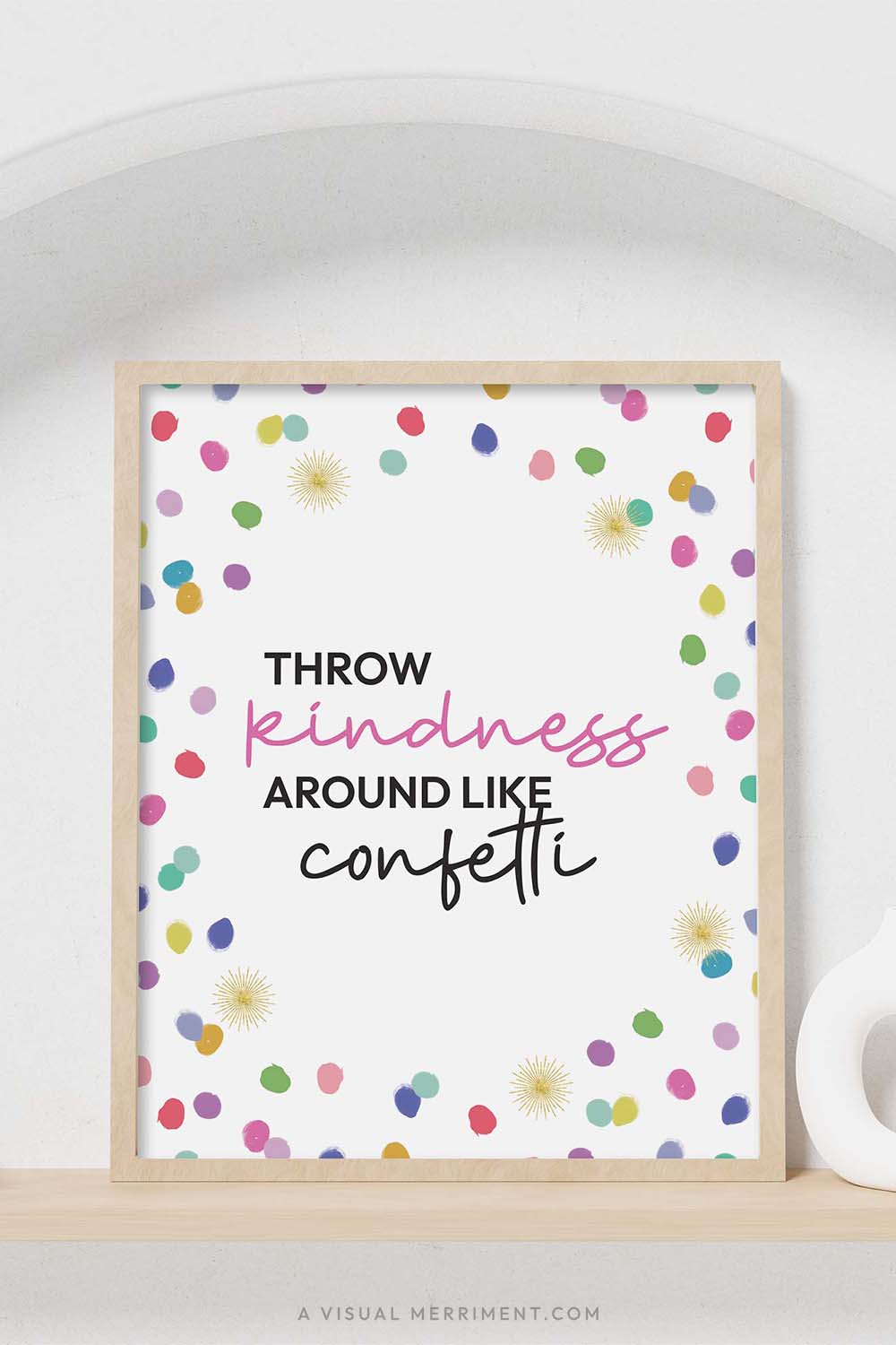 colorful rainbow polka dots ‘throw kindness around like confetti’ party sign in a frame sitting on a shelf