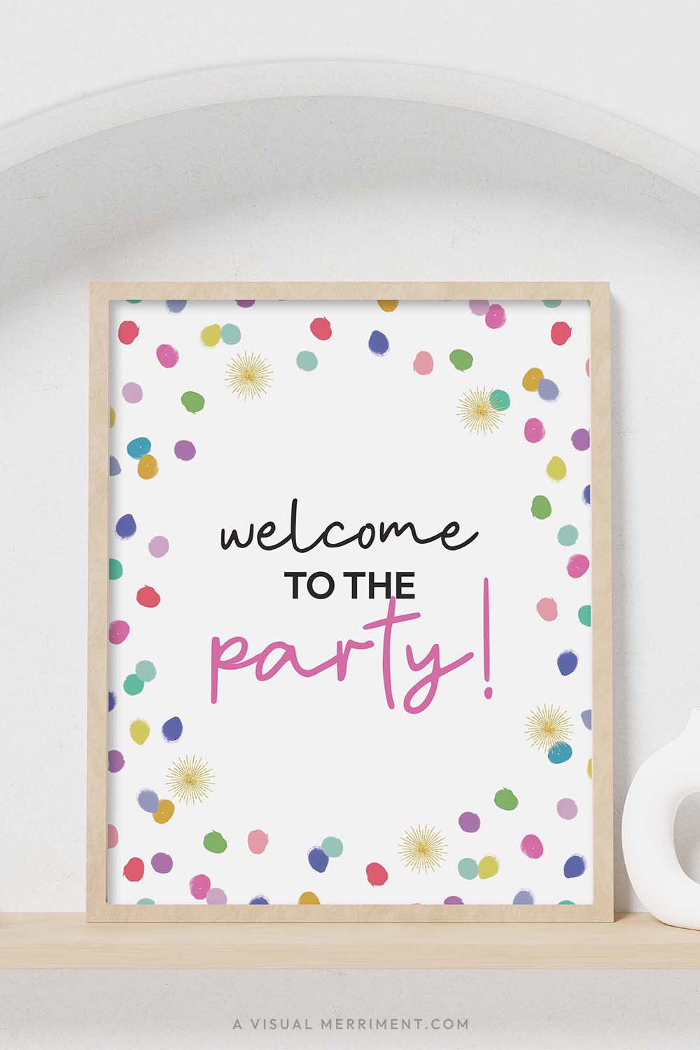 colorful rainbow confetti polka dots ‘welcome to the party’ party sign in a frame sitting on a shelf