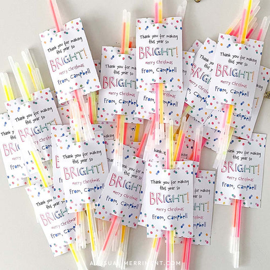 pile of made merry christmas glow stick holder tags with glow sticks inserted