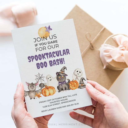 hands holding spooktacular boo bash halloween invitation with cute watercolor characters