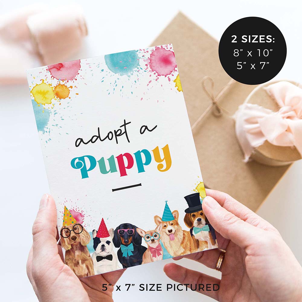hands holding adopt a puppy birthday party sign with party dogs and gifts in background