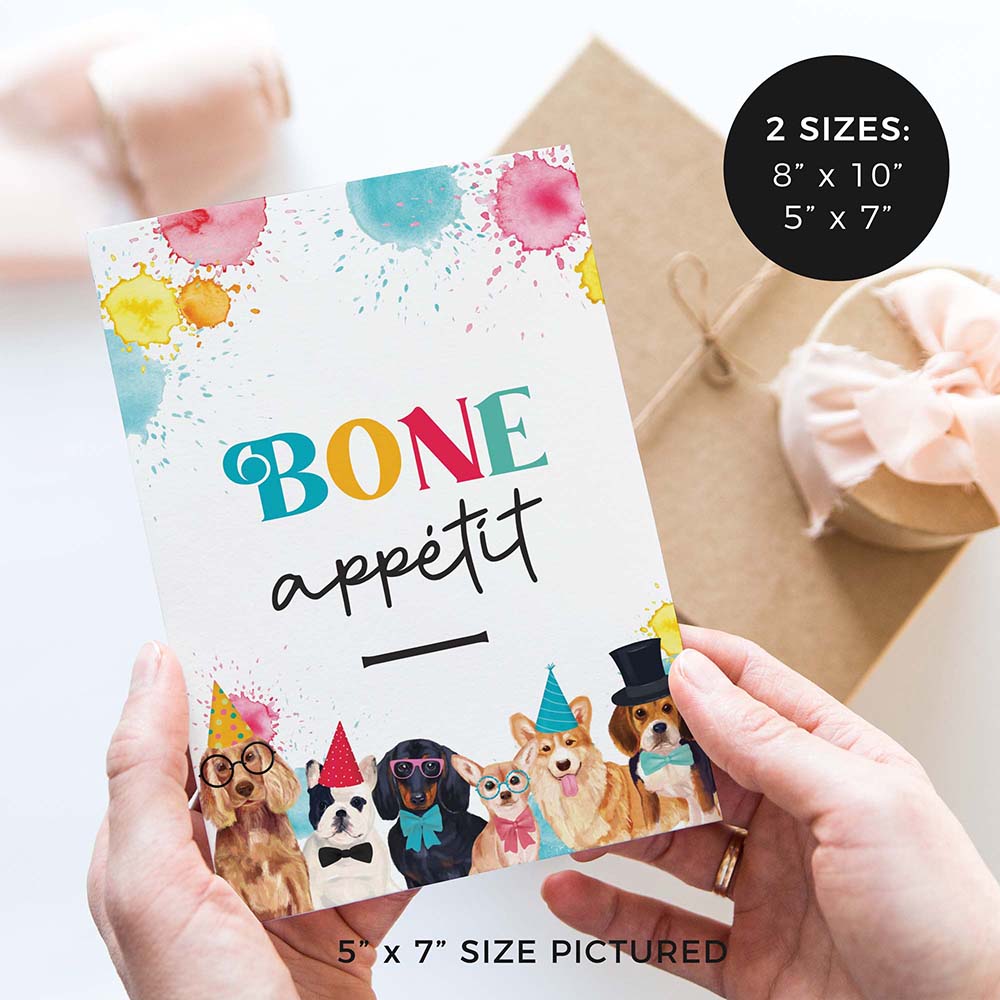 hands holding bone appetit birthday party sign with party dogs and gifts in background
