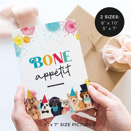 hands holding bone appetit birthday party sign with party dogs and gifts in background