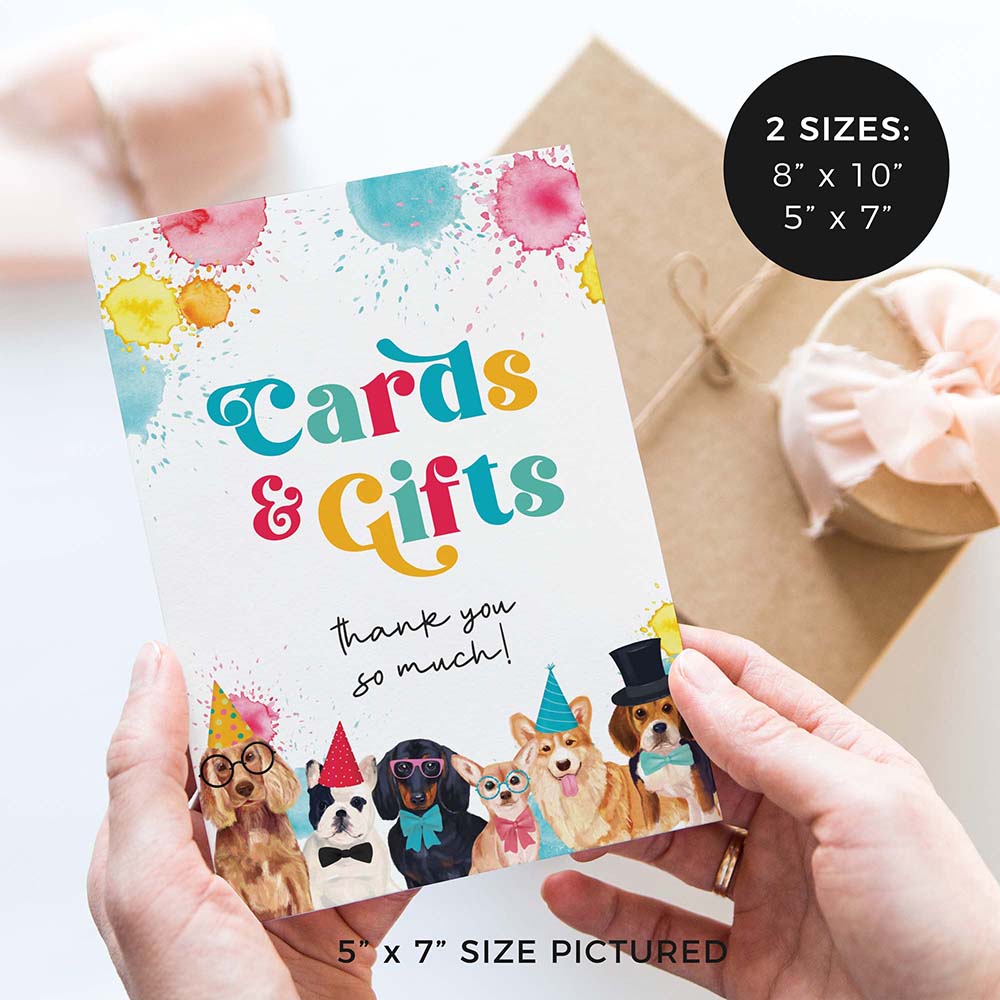 hands holding cards and gifts birthday party sign with party dogs and gifts in background