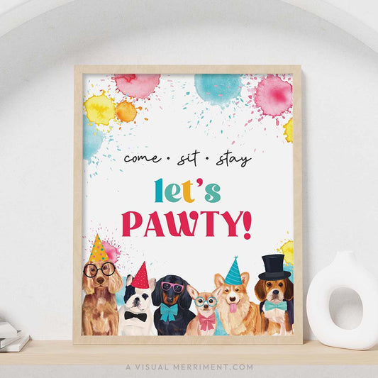 colorful come, sit, stay - let’s pawty dog party welcome sign with in a frame sitting on a shelf