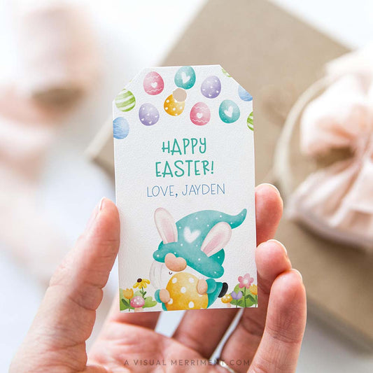 Hand holding a personalized Easter gift tag with a colorful green gnome design