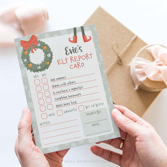 hands holding report card from elf on the shelf