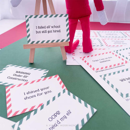 printed funny elf on the shelf props signs on easel next to elf doll