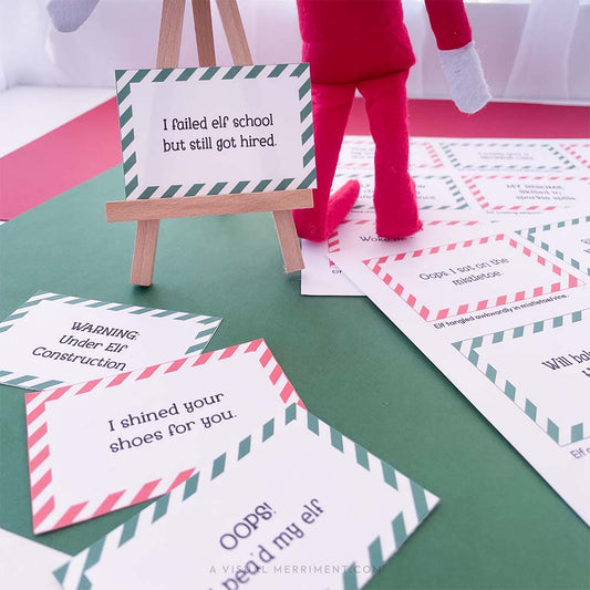 printed funny elf on the shelf props signs on easel next to elf doll