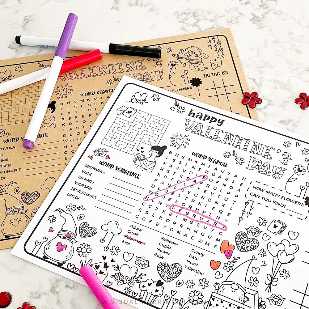 Valentine's Day activity sheets with markers on a marble surface