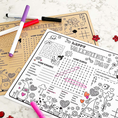 Valentine's Day activity sheets with markers on a marble surface