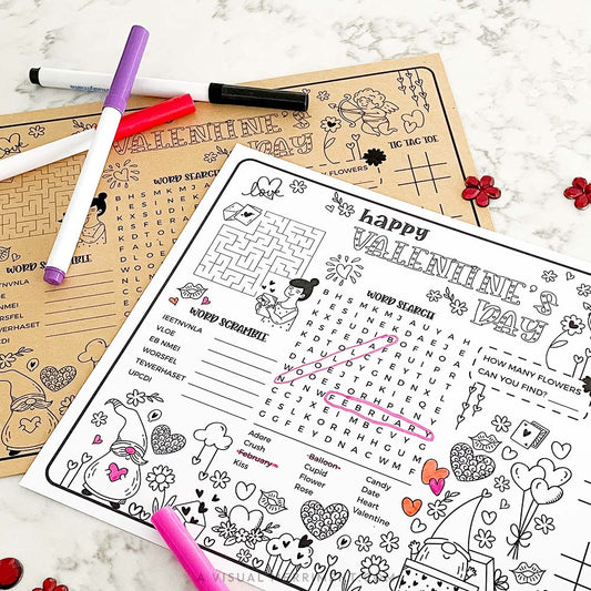 Valentine's Day activity sheets with markers on a marble surface