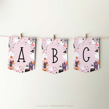 pink halloween banner with ghosts, cats and celestial elements. has letters a, b, c with banner strung with pegs on rope