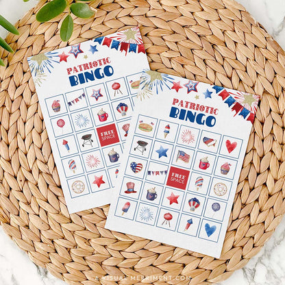 2 patriotic bingo game cards on mat with marble background