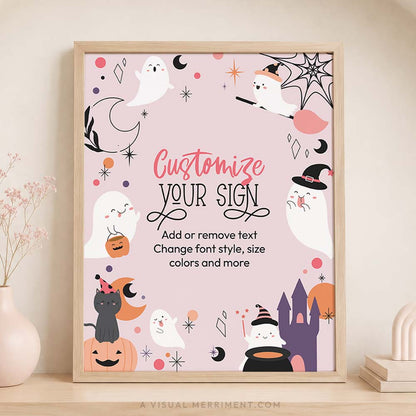 printable pink ghost halloween sign sits in frame on timber shelf with soft pink accessories