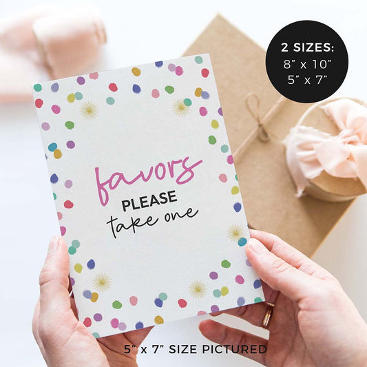hands holding ‘Favors please take one’ wedding sign with rainbow confetti polka dot design and gifts in background