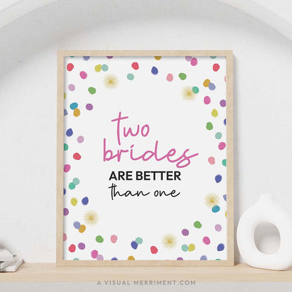 colorful rainbow confetti polka dots ‘two brides better than one’ party sign in a frame sitting on a shelf