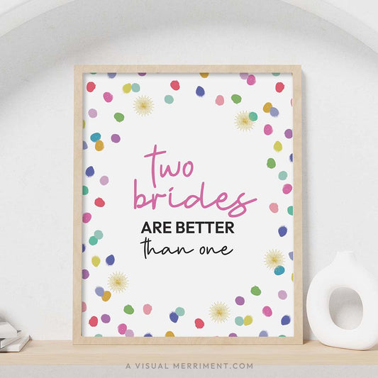 colorful rainbow confetti polka dots ‘two brides better than one’ party sign in a frame sitting on a shelf