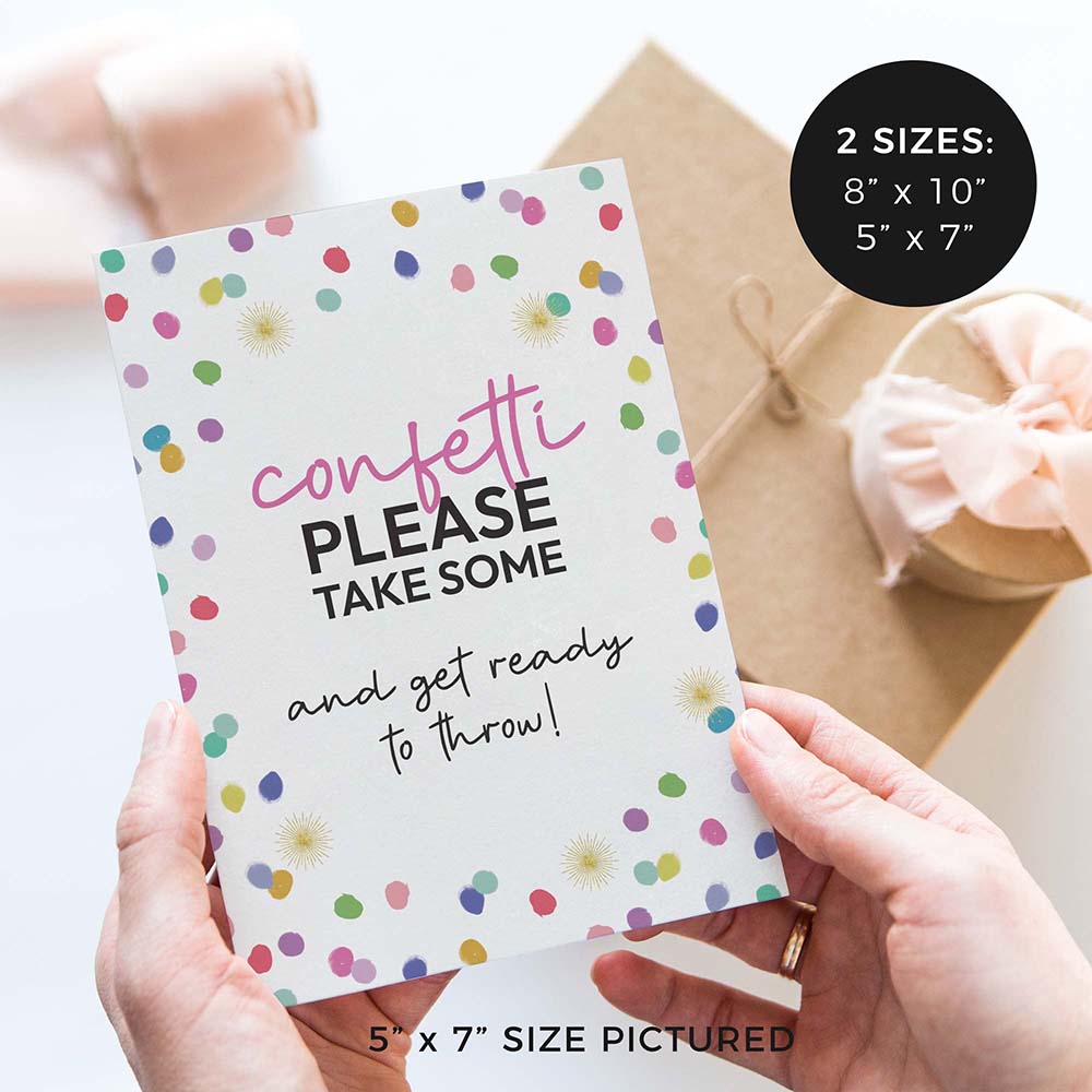 hands holding ‘please take confetti’ wedding sign with rainbow confetti polka dot design and gifts in background