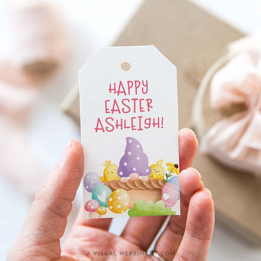 Hand holding a personalized Easter gift tag with a colorful purple basket gnome design