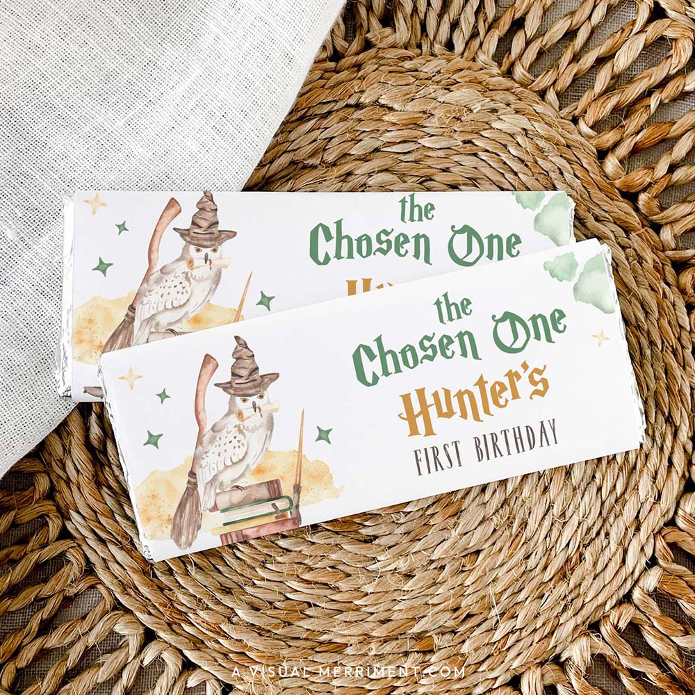 2 custom chocolate wrappers on candy with harry potter inspired chosen one magic school design on a woven mat