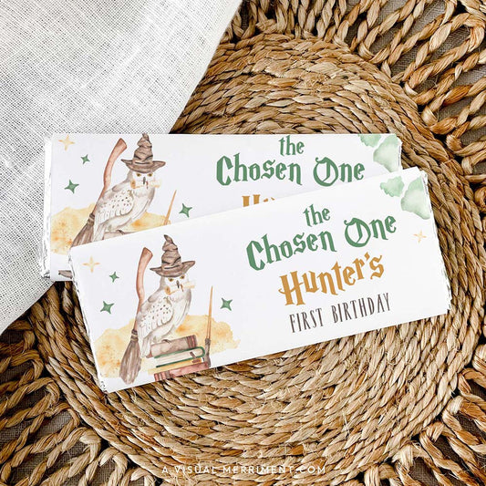 2 custom chocolate wrappers on candy with harry potter inspired chosen one magic school design on a woven mat