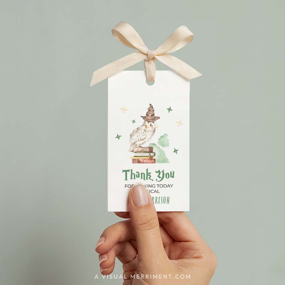 Hand holding printable gift tag with owl and books design in a harry potter style theme
