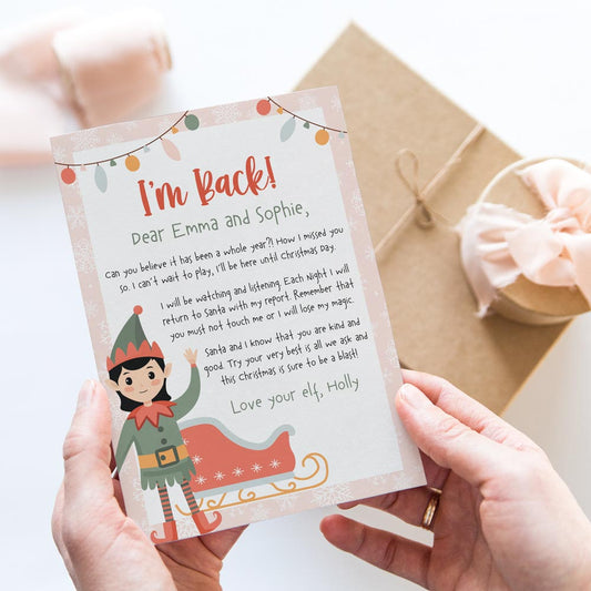 hands holding I'm back return arrival letter from girl elf on the shelf