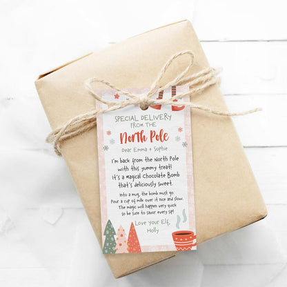 editable pink christmas elf hot chocolate bomb instructions gift tag on wrapped gift