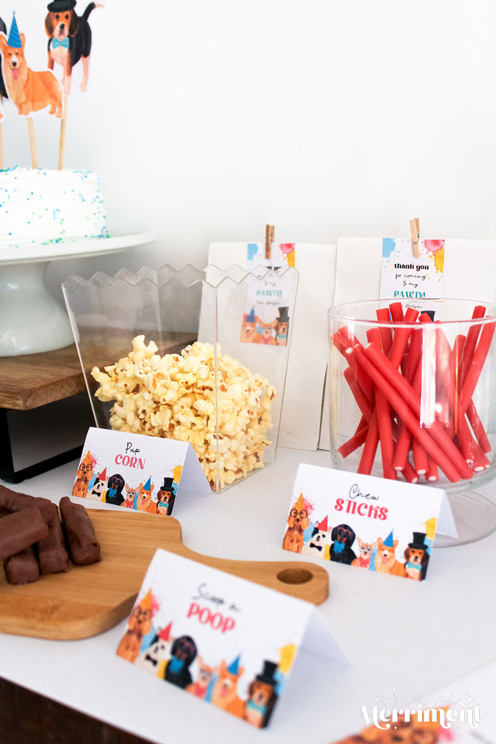 Party snacks on table with themed party dog birthday place card food tents