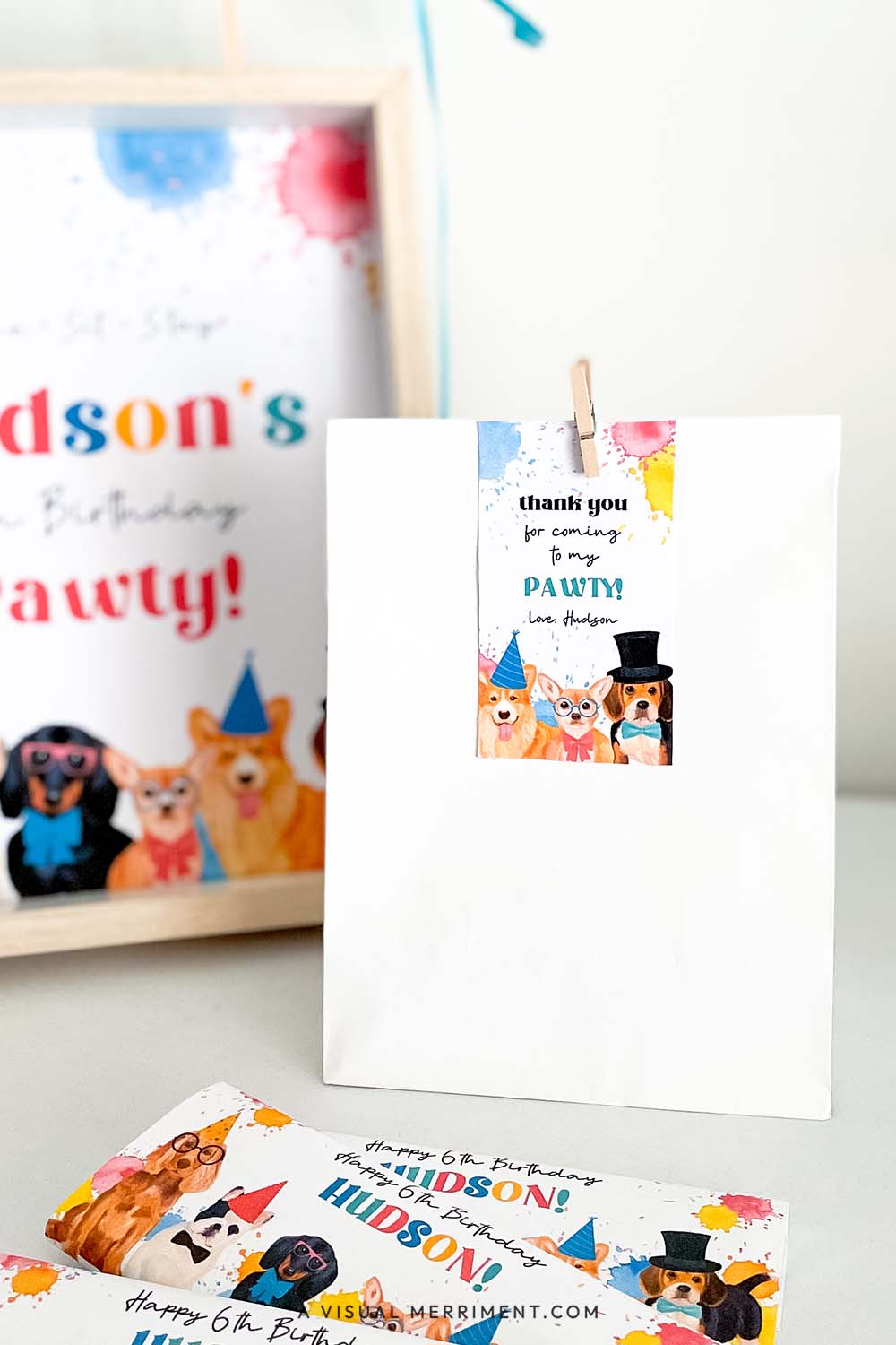 gift bag with dog party pawty thank you tag on party table with signs