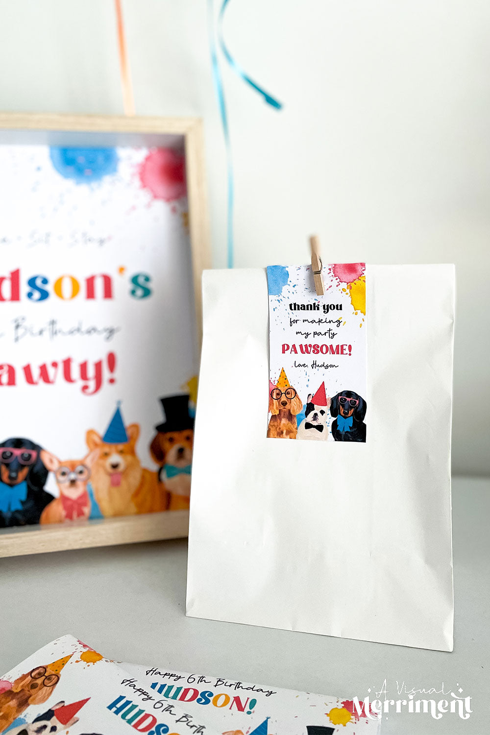 gift bag with dog party pawsome thank you tag on party table with signs