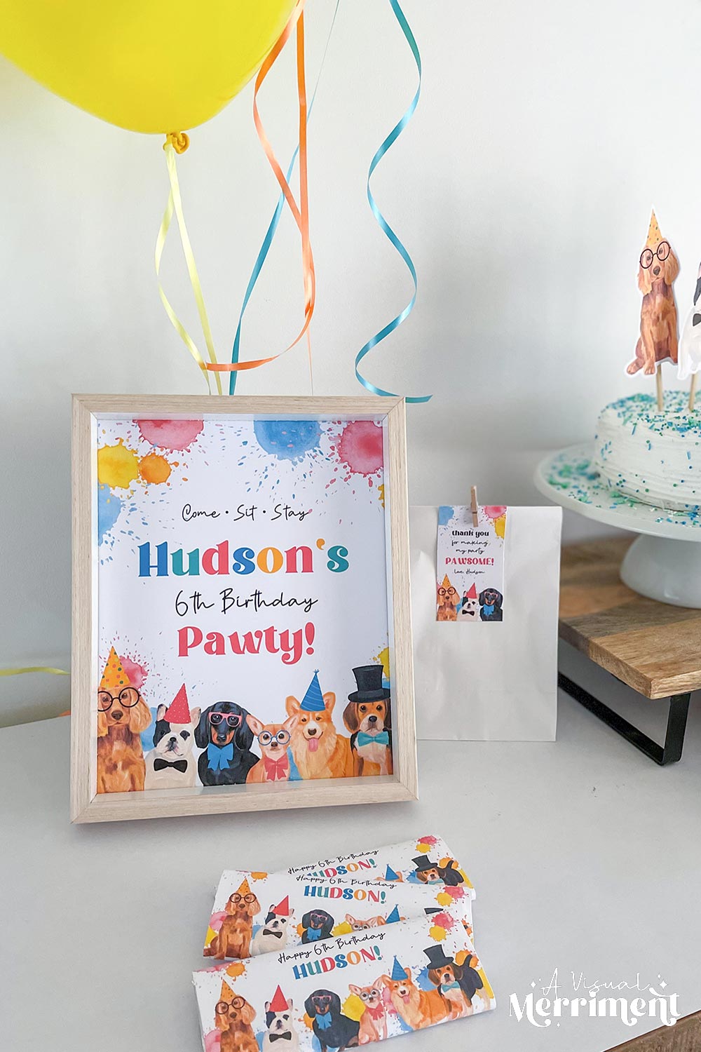 hudsons 6th birthday party sign with balloons, favor bags and treats for a dog party