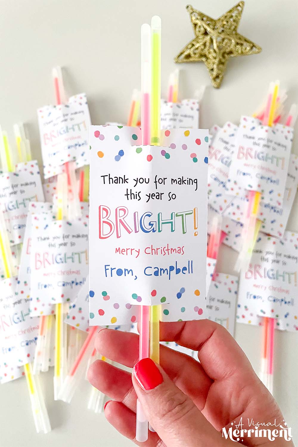 hand holding glow stick inserted into a printable glow stick holder with others in background