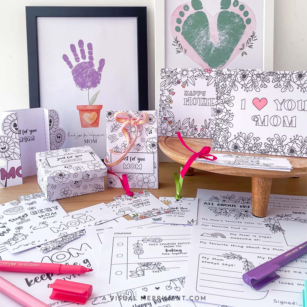 printed gifts for mom, including cards, coloring pages, and markers on a wooden surface.