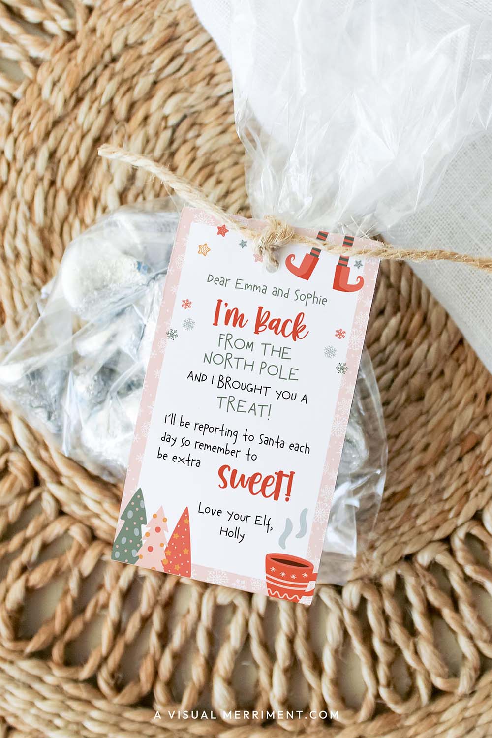 pink girl christmas elf i’m back gift tag tied to bag of candy treats