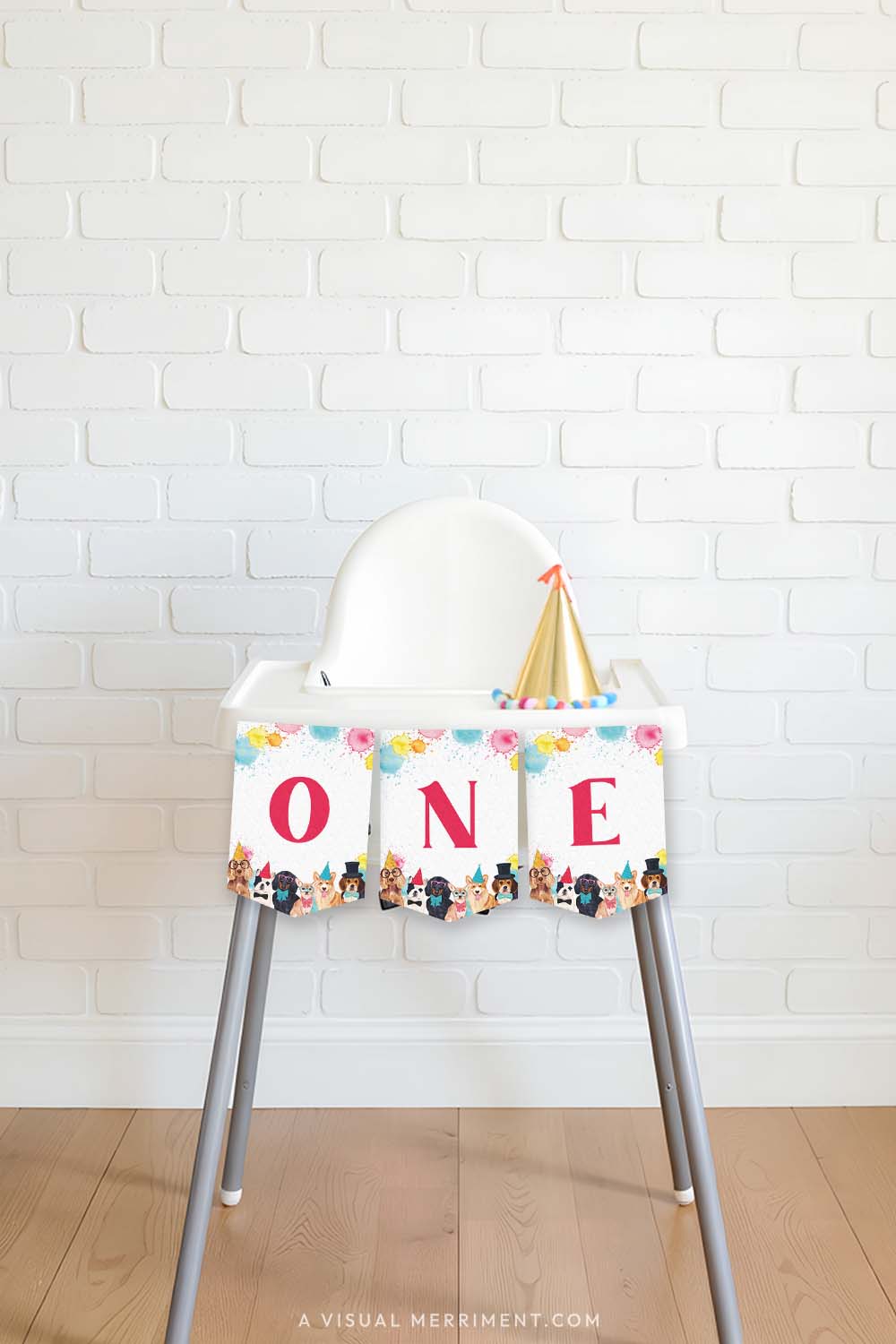 high chair with red pawty dogs printed ONE banner flags, party hat against brick wall