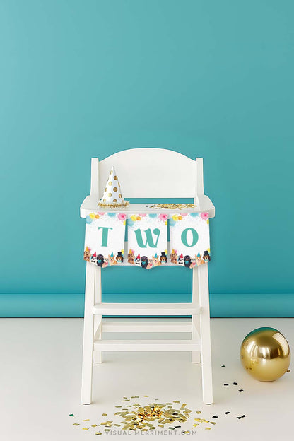 vertical of White high chair with a green 'TWO' printable dog party banner and party hat