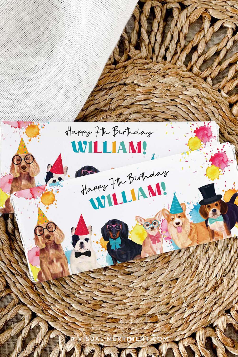 Vertical of custom chocolate wrappers on candy bars with colorful party dogs laid on a woven mat