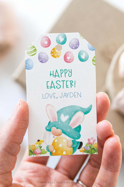 vertical of Hand holding a personalized Easter gift tag with a colorful green gnome design