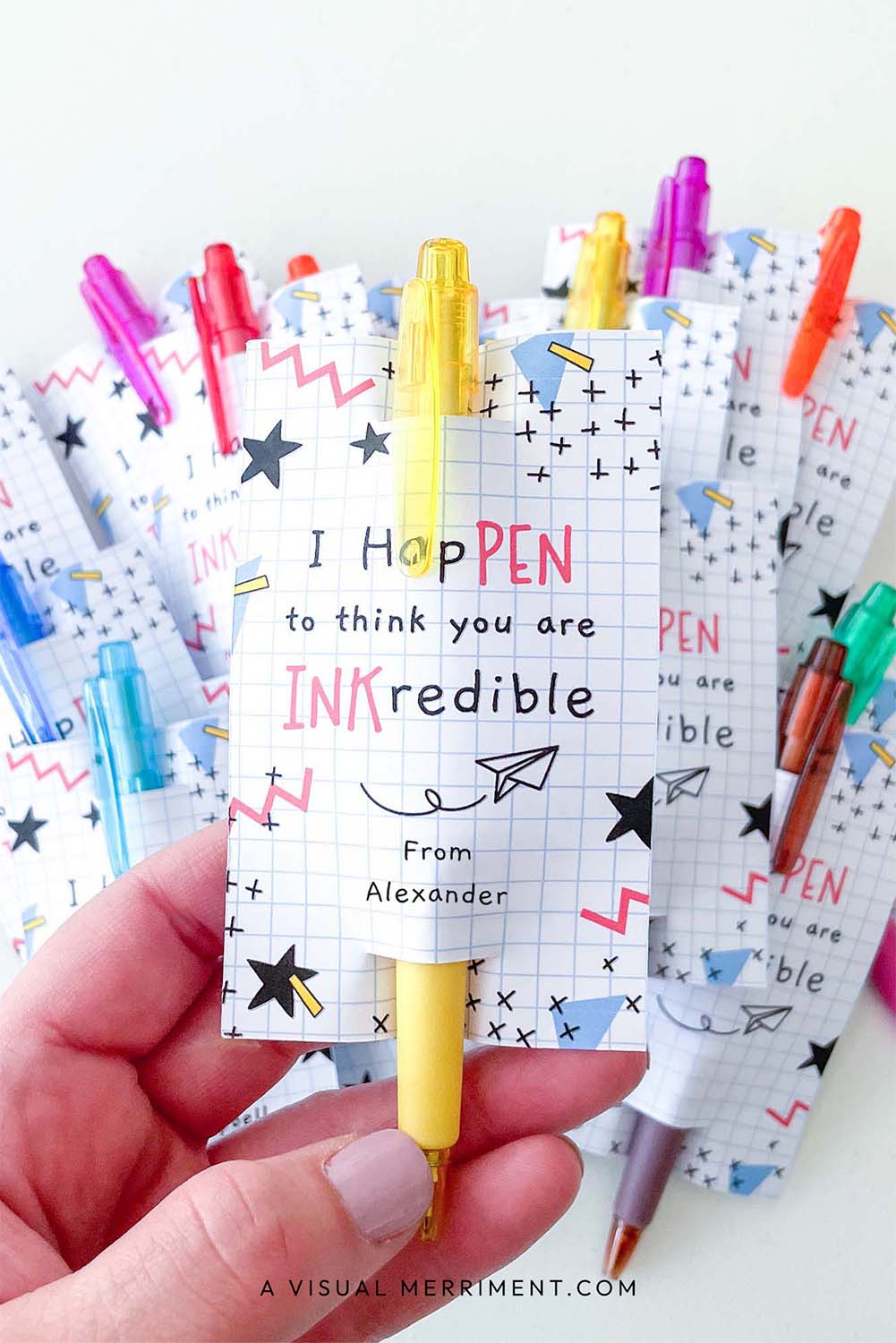 vertical of hand holding inkcredible printable gift tag with pen