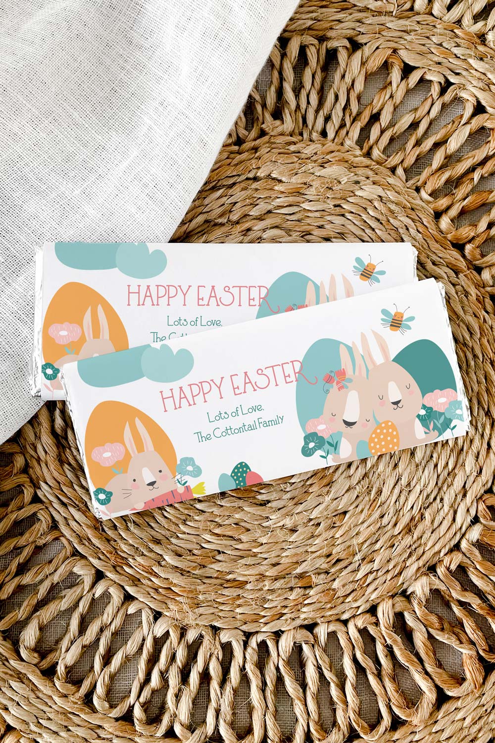 two Easter chocolate wrapper s in cute spring bunny design wrapped on candy on grass mat